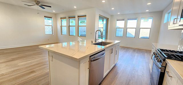 a kitchen with counter space wooden floor and appliances