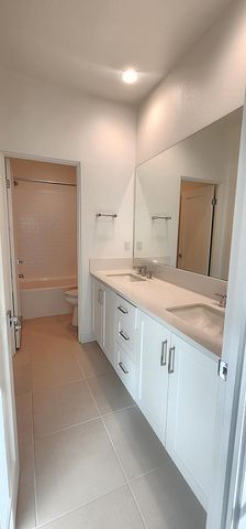 a spacious bathroom with a sink a mirror and a vanity