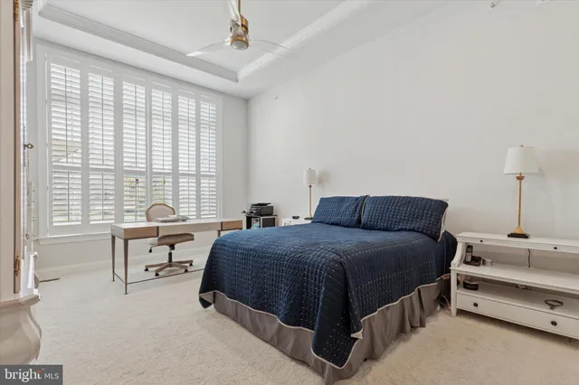 a spacious bedroom with a bed and a large window