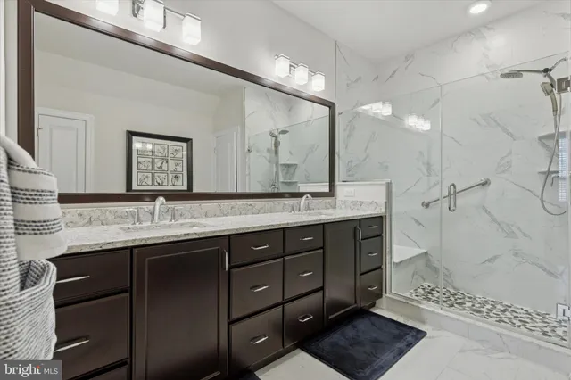 a bathroom with a sink double vanity and a mirror