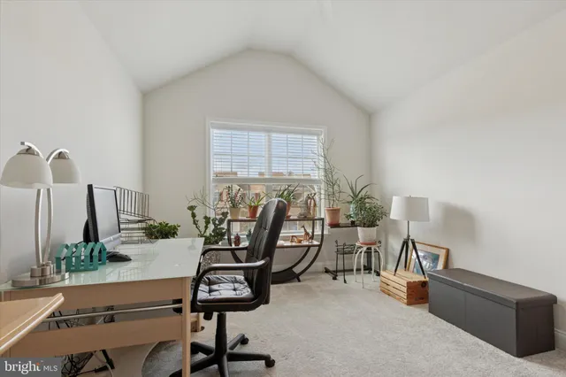 a view of a workspace with furniture and a potted plant