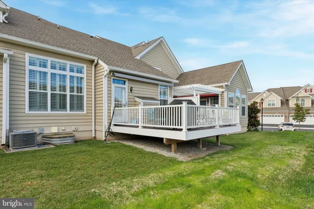 a view of a house with a yard and deck