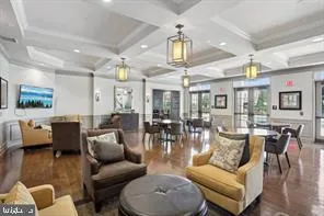 a living room with furniture kitchen and a chandelier