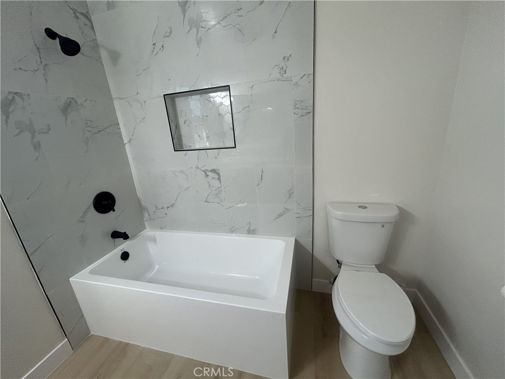 2361 Faust Avenue Long Beach, CA 90815 - Photo 11 of 20 a white toilet sitting next to a tub