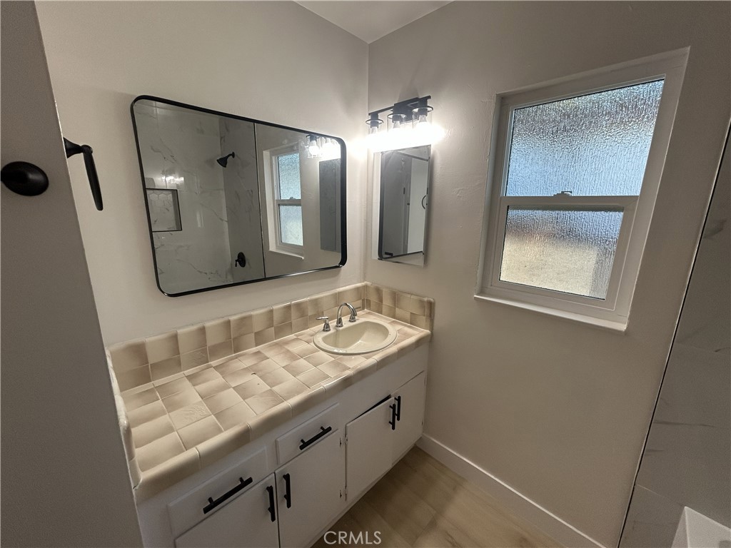 2361 Faust Avenue Long Beach, CA 90815 - Photo 12 of 20 a bathroom with a sink and a mirror