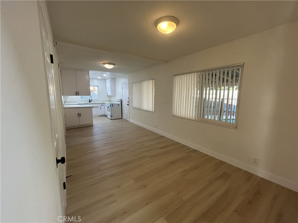 2361 Faust Avenue Long Beach, CA 90815 - Photo 14 of 20 an empty room with wooden floor and windows