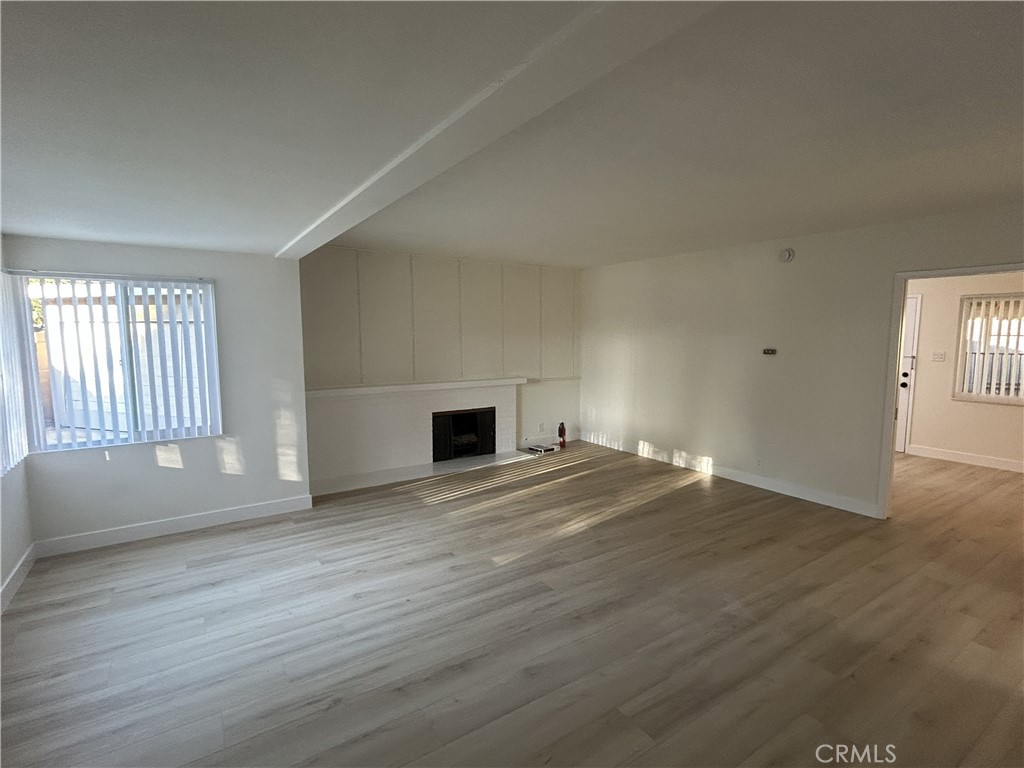 2361 Faust Avenue Long Beach, CA 90815 - Photo 2 of 20 an empty room with wooden floor and windows
