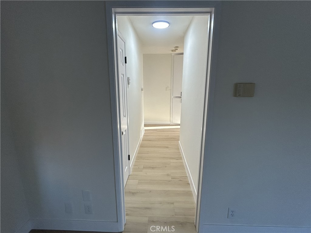 2361 Faust Avenue Long Beach, CA 90815 - Photo 5 of 20 a view of a hallway with a wooden door
