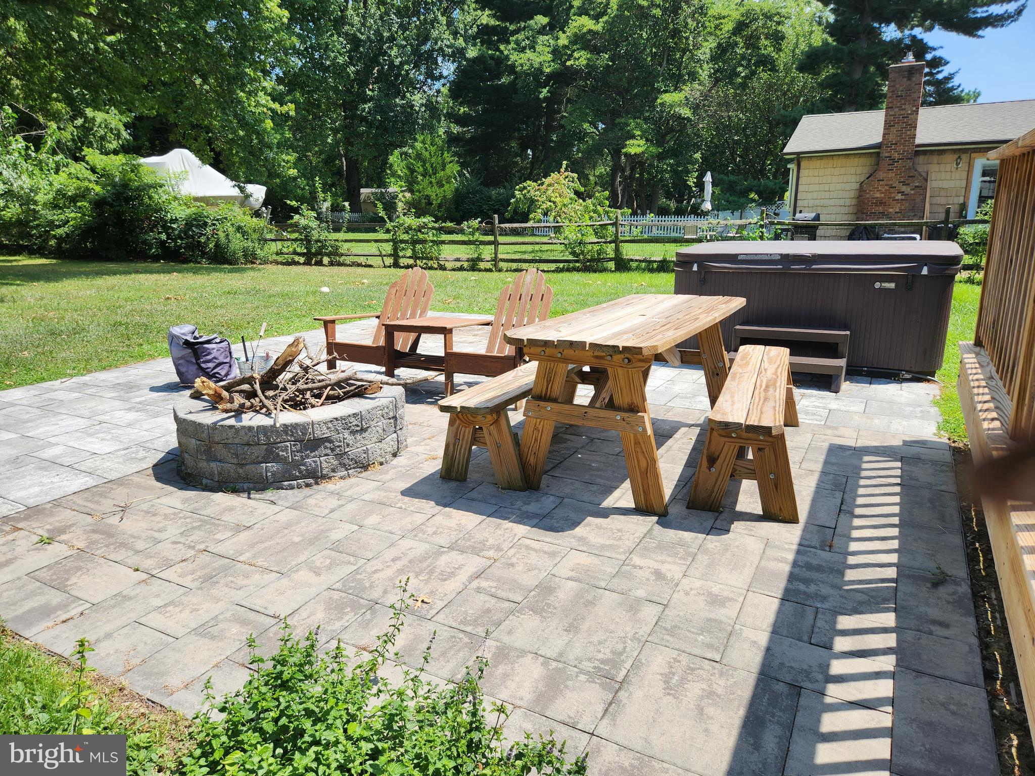 908 May Lane Stevensville, MD 21666 - Photo 4 of 17 Patio with firepit and hot tub
