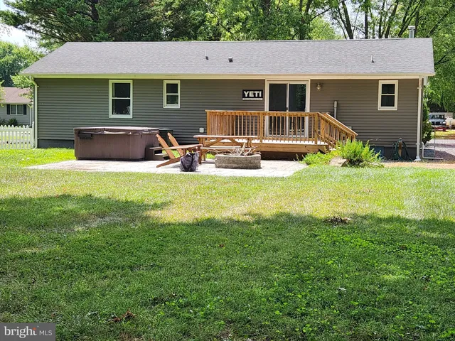 a front view of house with yard slide and outdoor seating