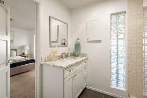 a spacious bathroom with double vanity and a mirror