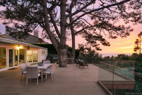 a view of a house with a yard balcony and sitting area
