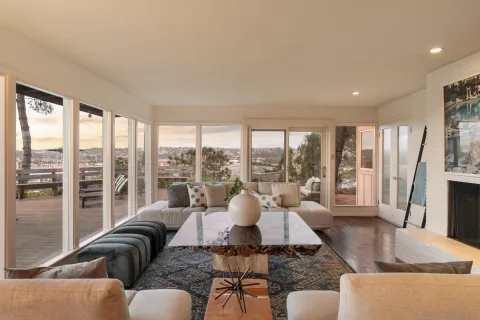 a living room with furniture and large windows
