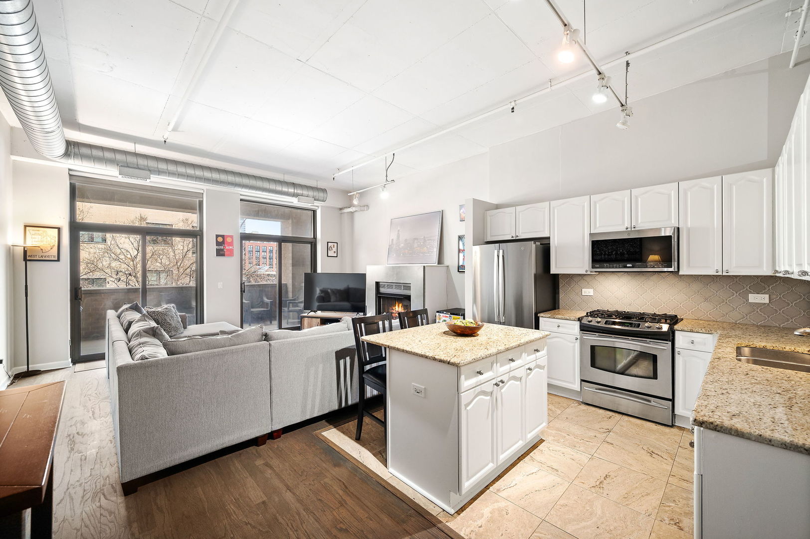 1301 West Madison Street, Unit 207 Chicago, IL 60607 - Photo 2 of 17 a open kitchen with stainless steel appliances a stove a sink and a refrigerator