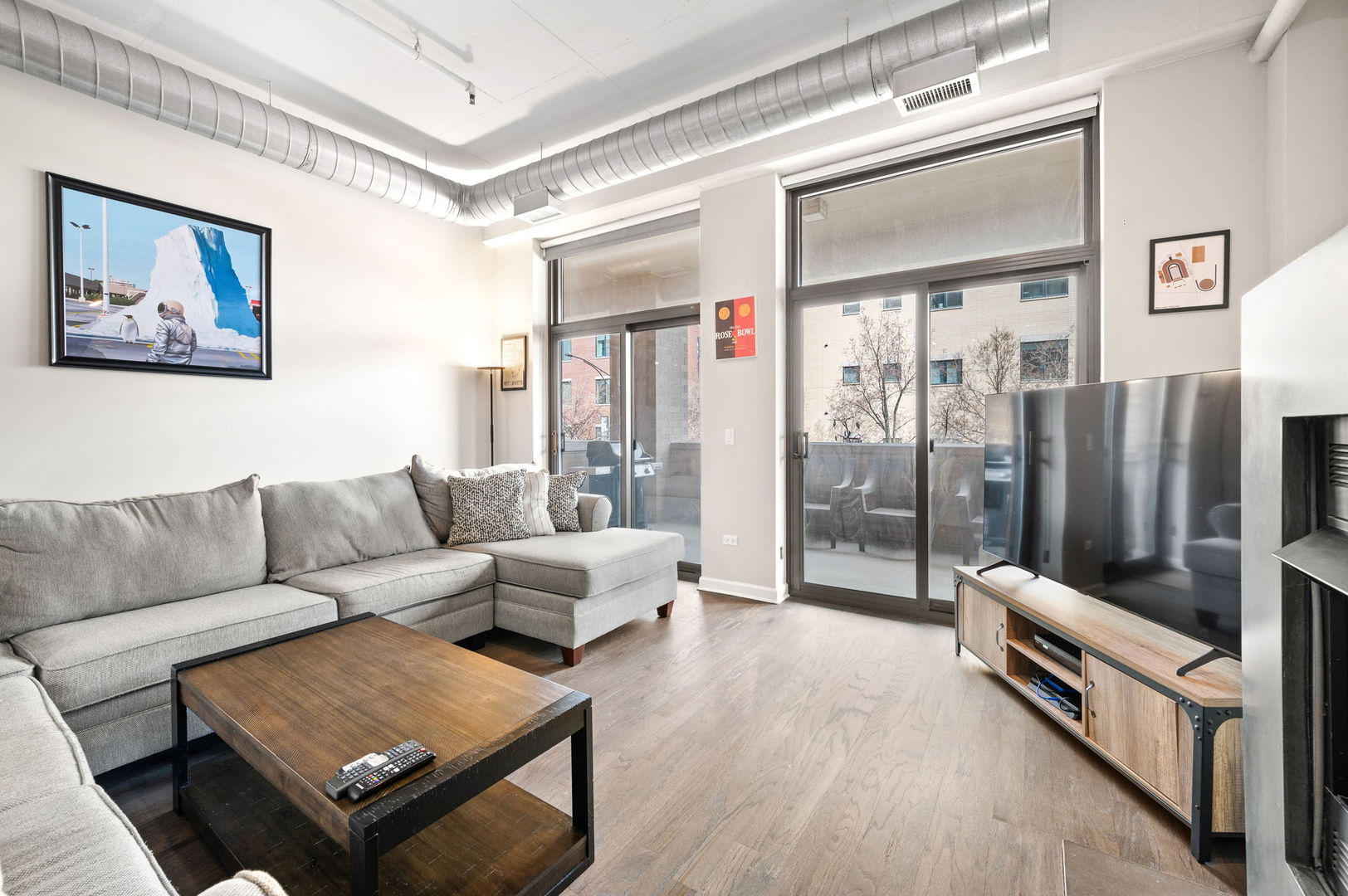 1301 West Madison Street, Unit 207 Chicago, IL 60607 - Photo 4 of 17 a living room with furniture and a floor to ceiling window