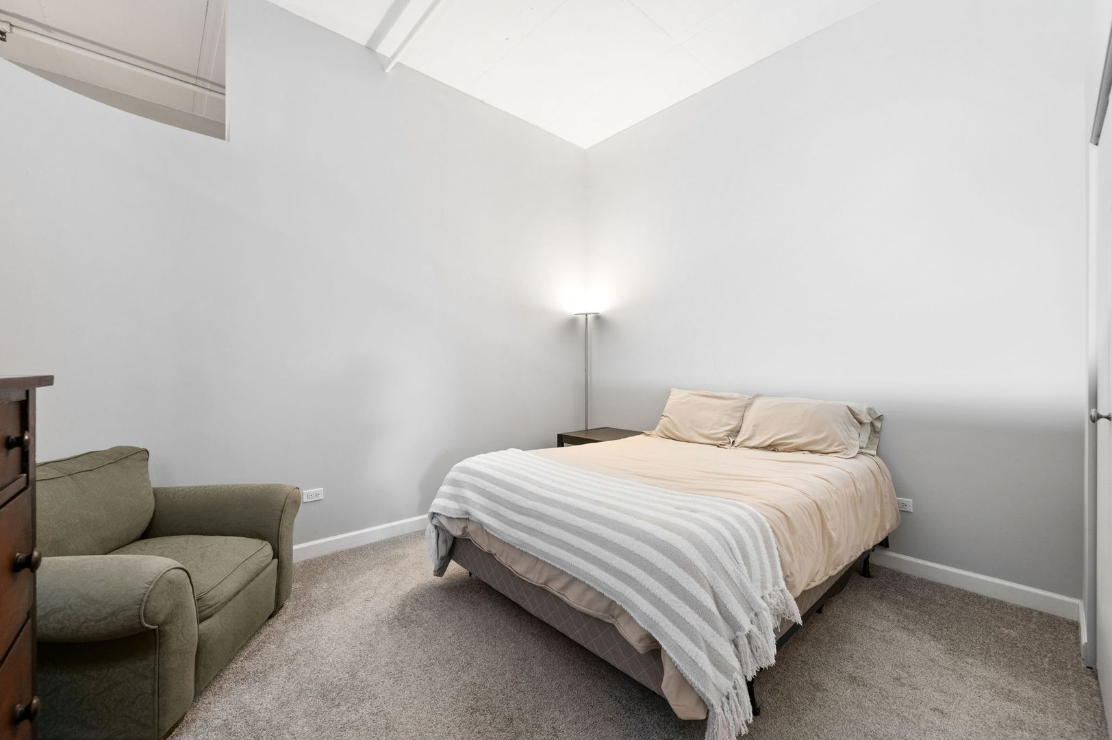 1301 West Madison Street, Unit 207 Chicago, IL 60607 - Photo 8 of 17 a bedroom with a bed and a couch