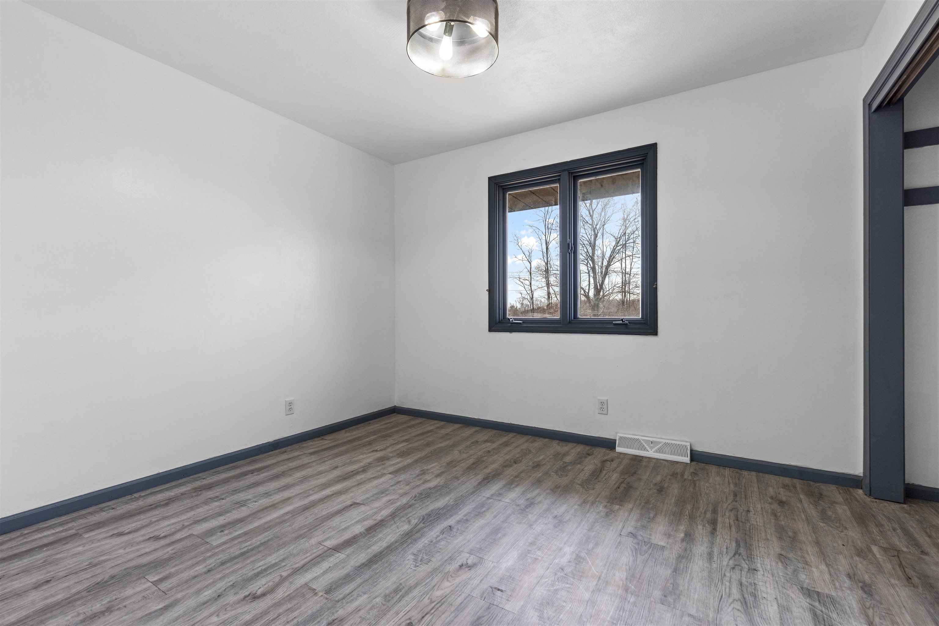 7010 Prairie Hill Road South Beloit, IL 61080 - Photo 9 of 21 a view of an empty room with wooden floor and a window