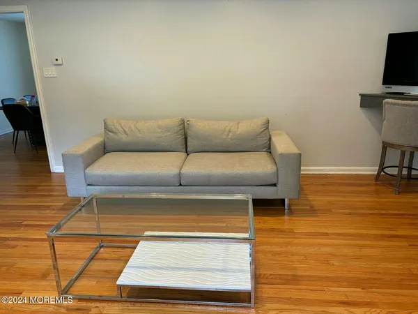 a living room with furniture wooden floor and a fireplace
