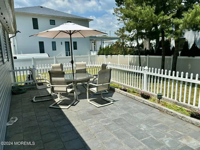 a spacious bedroom with a bed and a chandelier