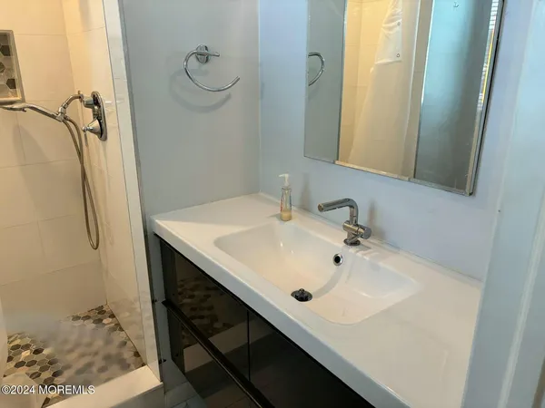 a bathroom with a sink and mirror