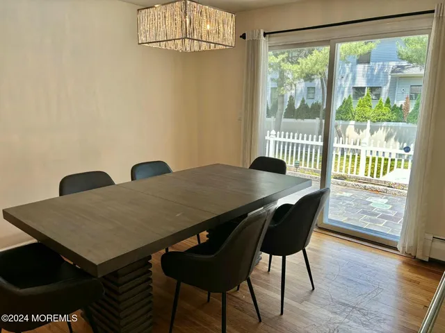 a kitchen with granite countertop white cabinets and a window