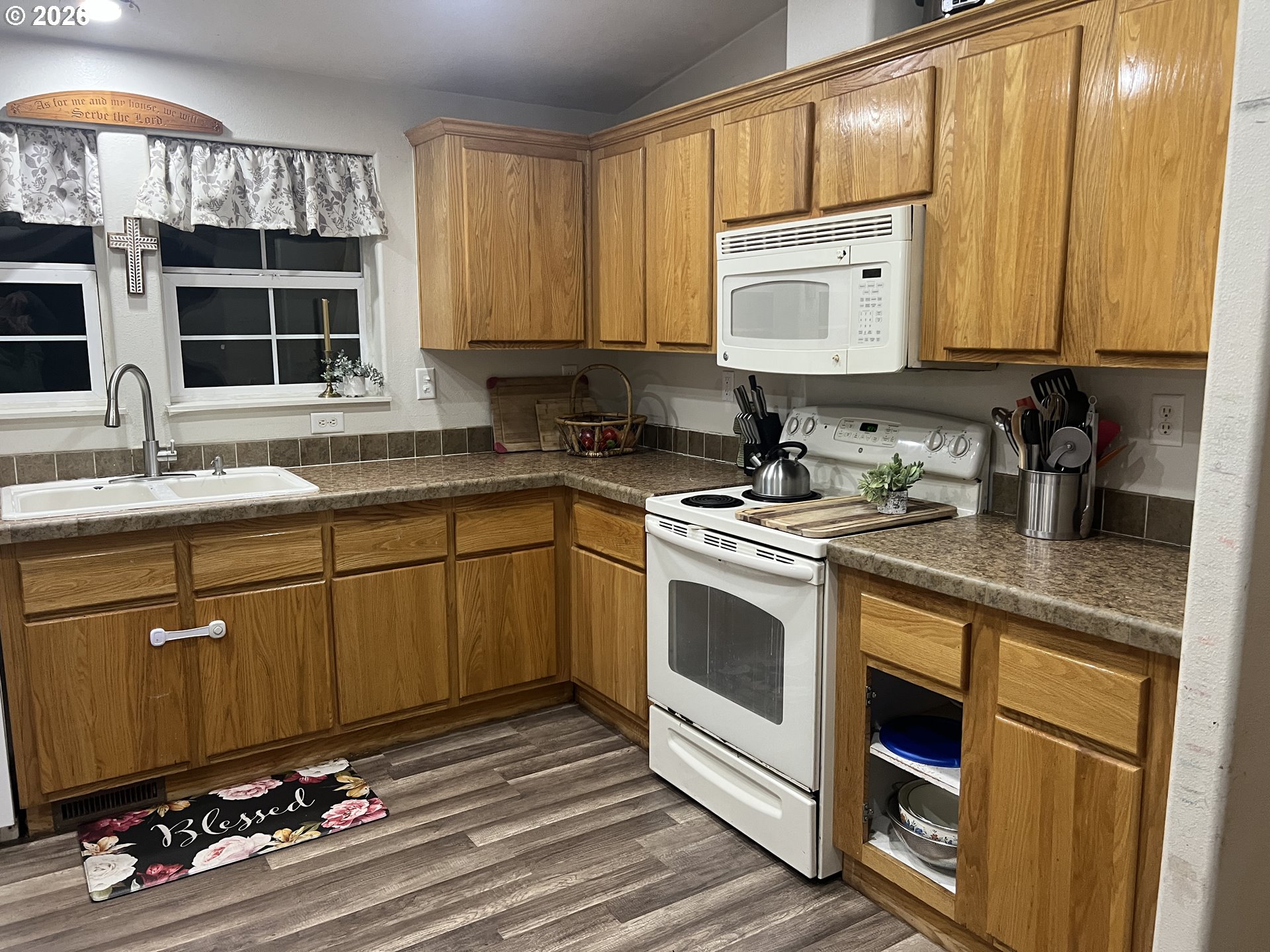 210 Northwest Grinstead Street Siletz, OR 97380 - Photo 13 of 29 a kitchen with stainless steel appliances a sink stove and cabinets