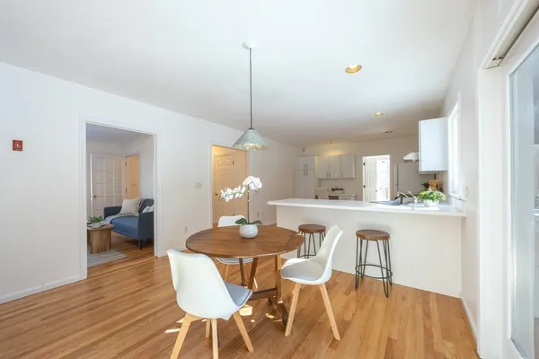 a dining room with furniture and wooden floor