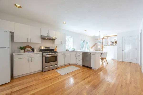 a kitchen with a white cabinets and white appliances