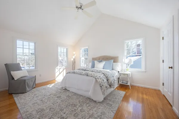 a bedroom with a bed and a chair