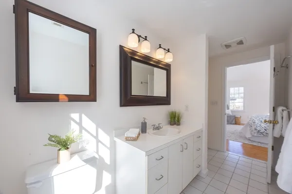 a bathroom with a double vanity sink mirror and