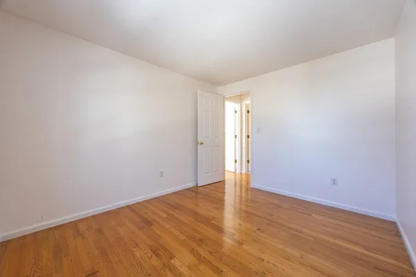 a view of an empty room and wooden floor