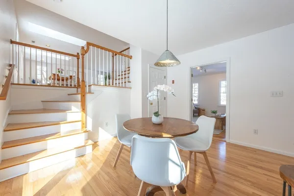 a dining room with furniture and wooden floor