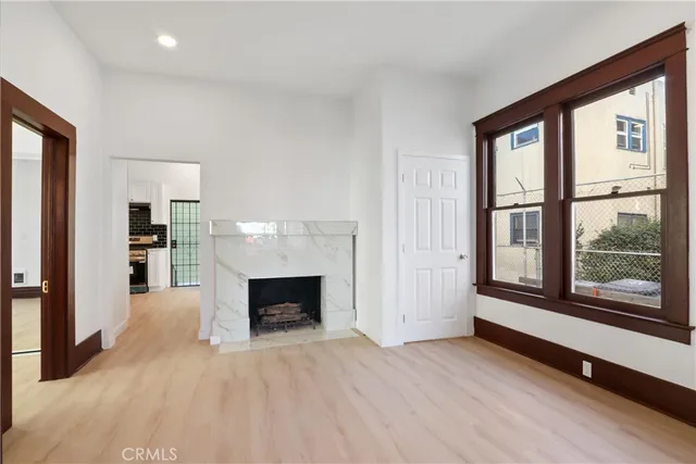 a view of living room with furniture and a fireplace