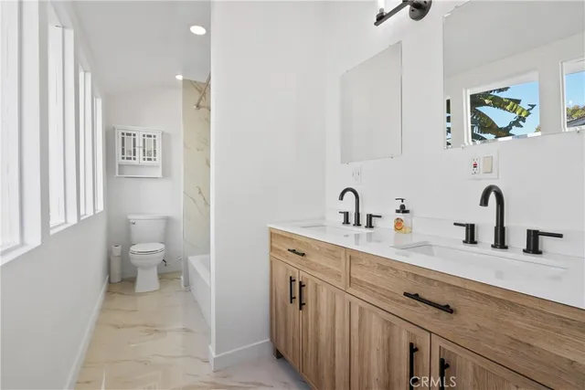 a spacious bathroom with a sink and a toilet