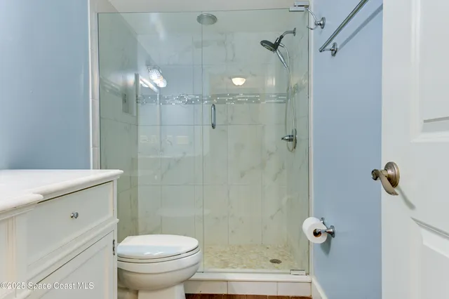 a bathroom with a shower a toilet and sink