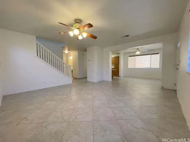 a view of a livingroom with a ceiling fan and window
