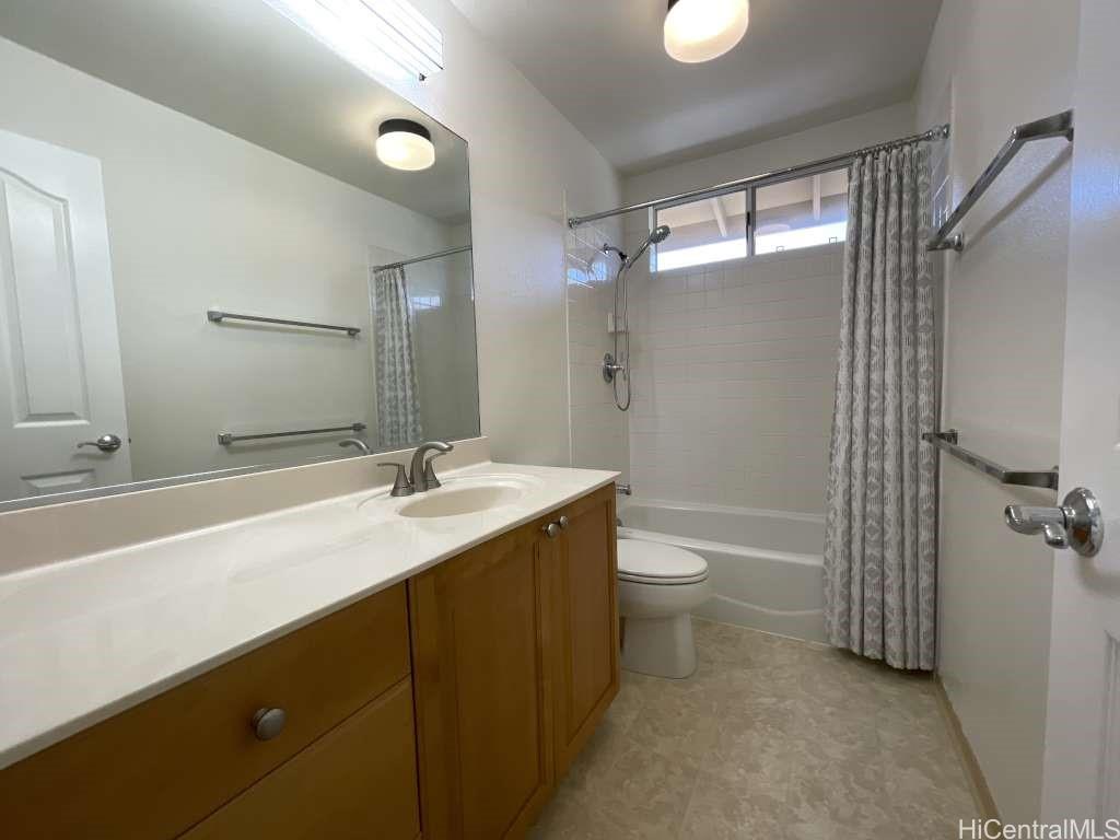 94-1027 Halekapio Street Waipahu, HI 96797 - Photo 8 of 13 a bathroom with a granite countertop sink toilet and shower