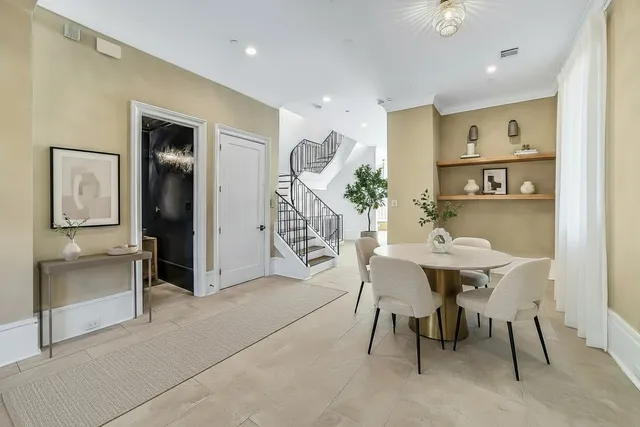 a bathroom with a toilet mirror and vanity