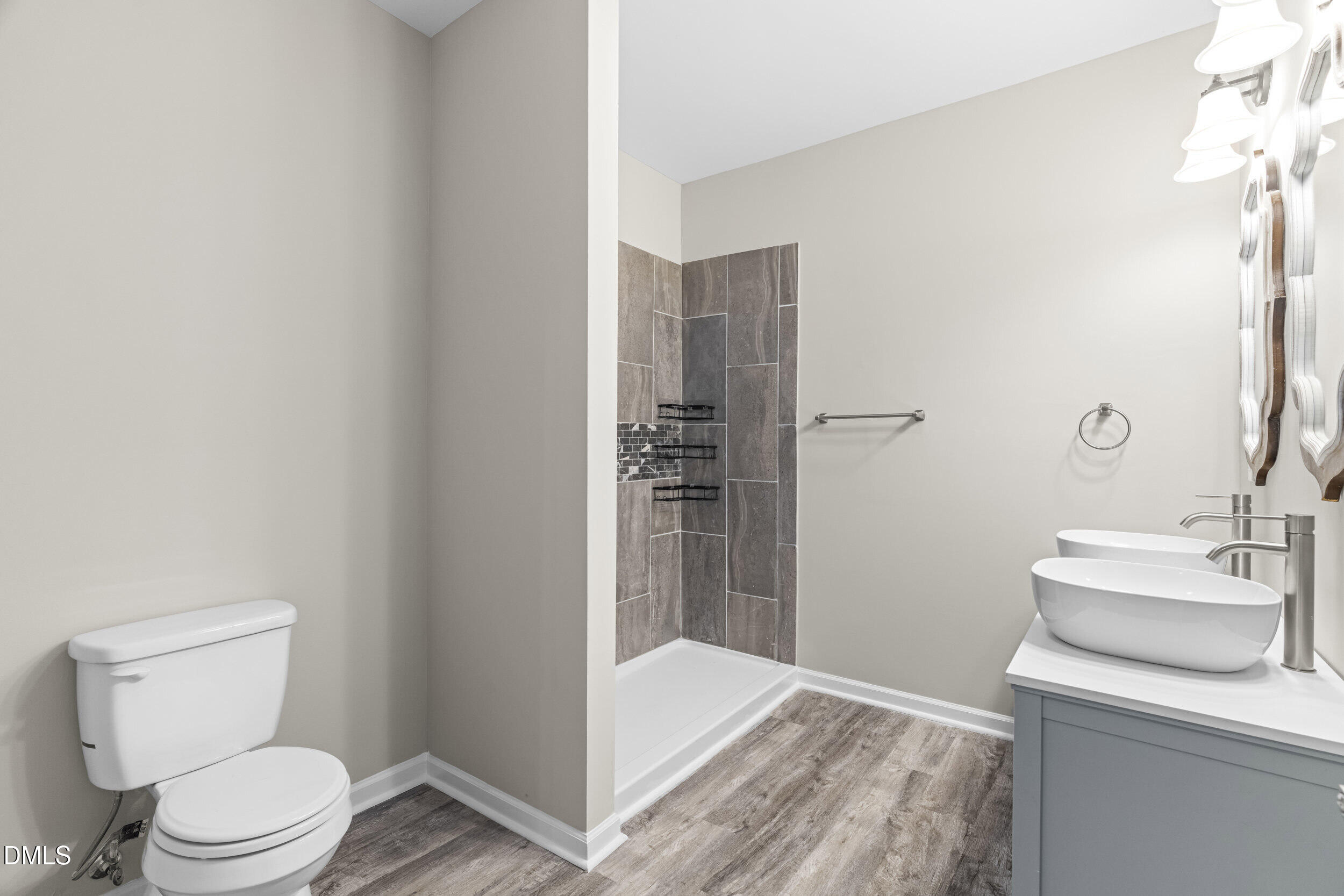 307 East J Street Erwin, NC 28339 - Photo 17 of 27 a bathroom with a sink a toilet and shower