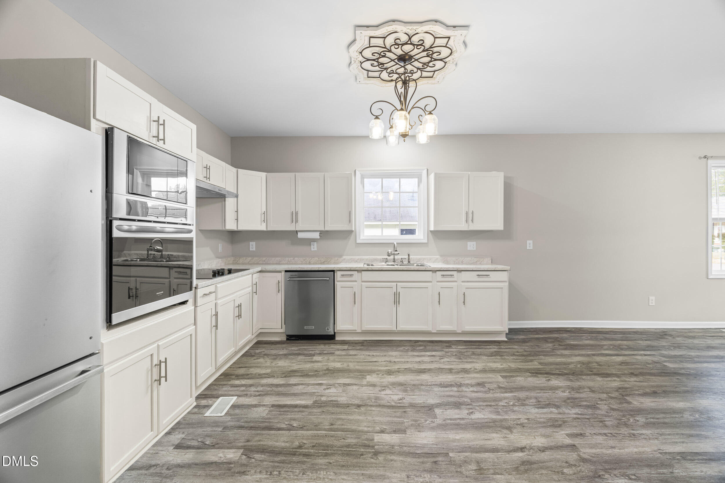 307 East J Street Erwin, NC 28339 - Photo 20 of 27 a kitchen with a refrigerator and a stove top oven