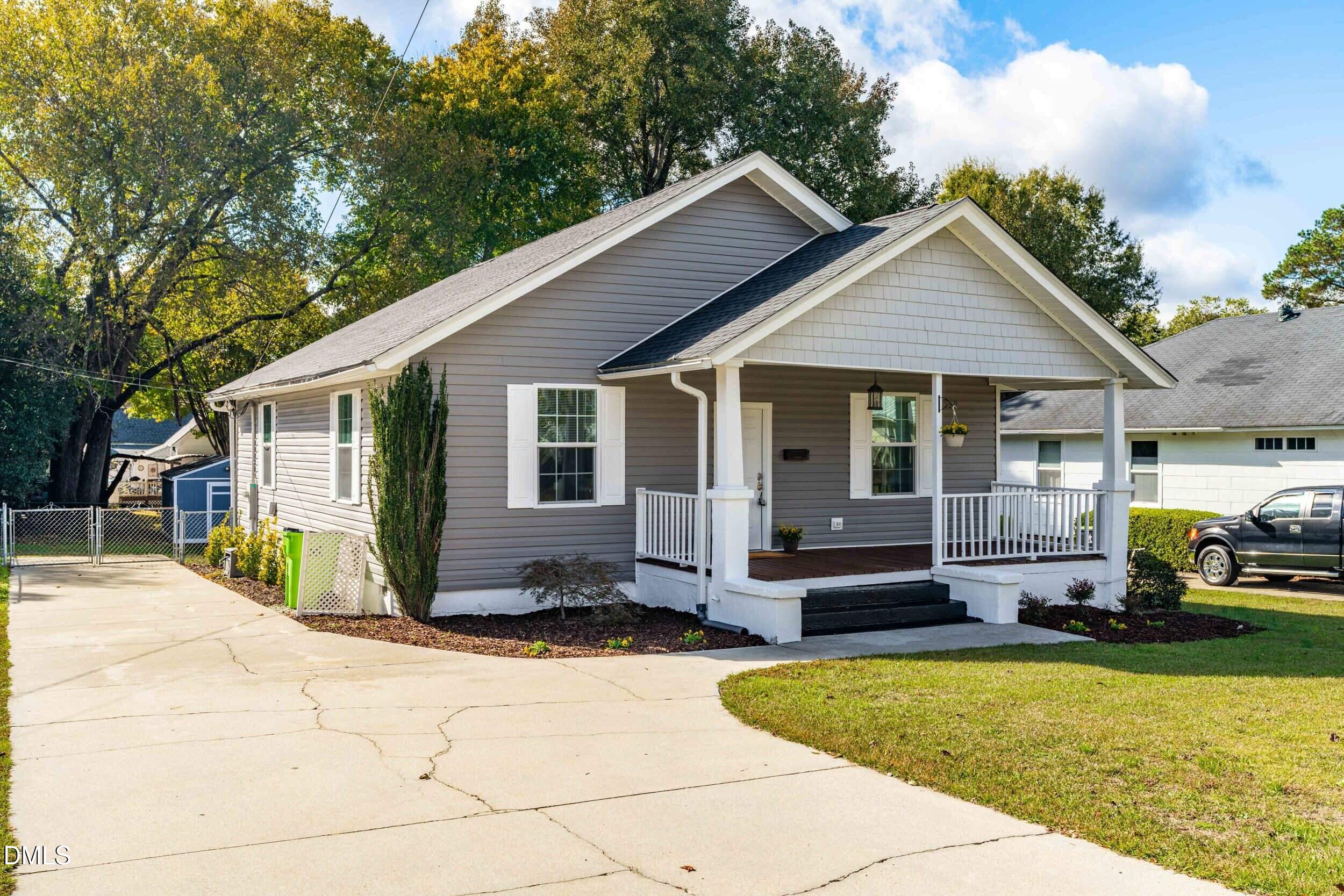 307 East J Street Erwin, NC 28339 - Photo 2 of 27 a front view of house with yard outdoor seating and barbeque oven