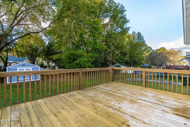 a view of balcony with wooden floor and fence