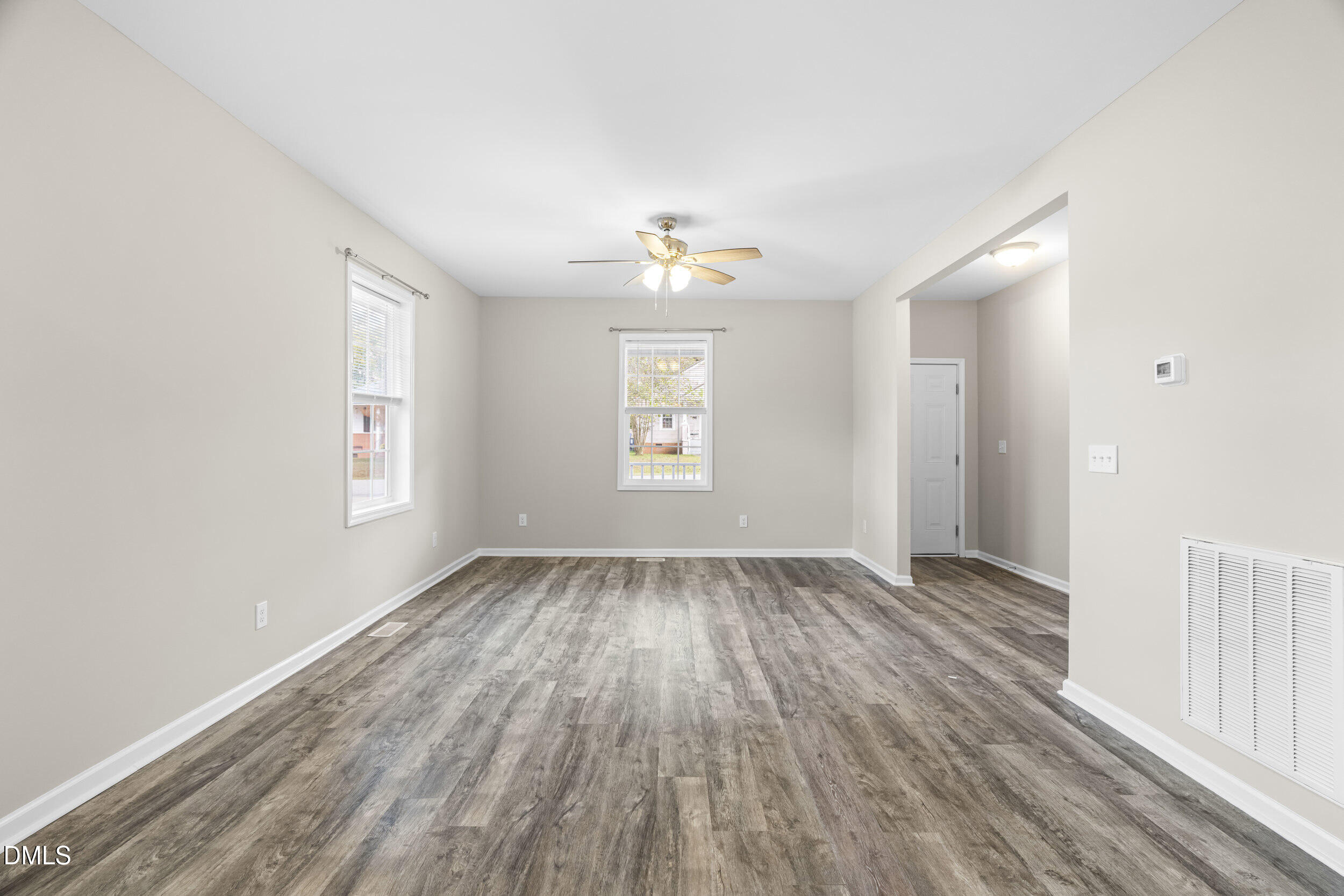 307 East J Street Erwin, NC 28339 - Photo 6 of 27 an empty room with wooden floor and windows