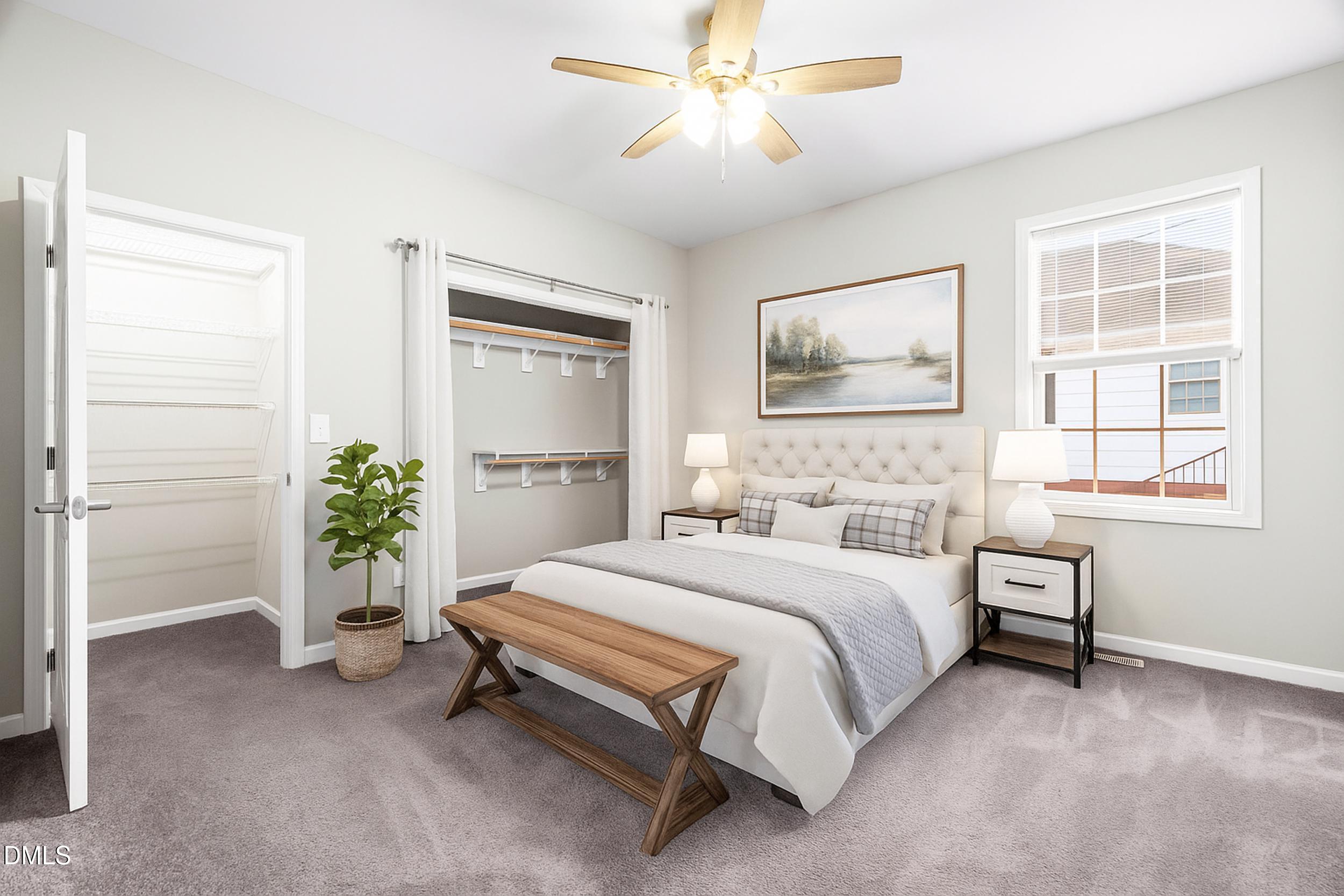 307 East J Street Erwin, NC 28339 - Photo 9 of 27 a bedroom with a bed and a potted plant