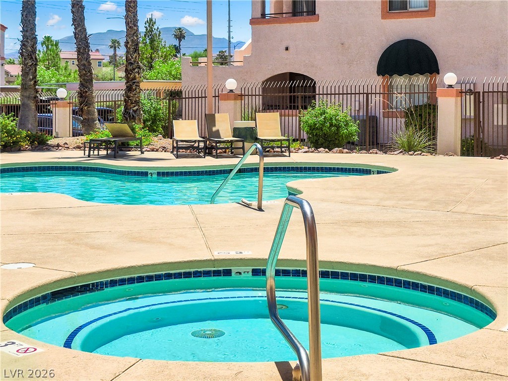 7570 West Flamingo Road, Unit 115 Las Vegas, NV 89147 - Photo 26 of 34 Relax poolside with this community pool and spa, perfect for recreation and leisure.