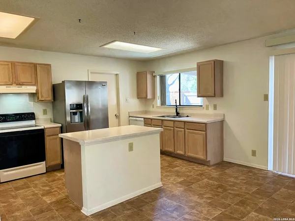 a kitchen with a sink stove and refrigerator
