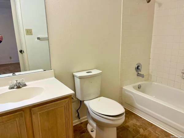 a bathroom with a sink a toilet and bathtub