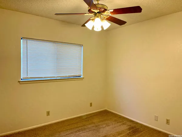 an empty room with a empty space and a ceiling fan