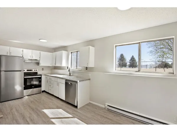 a kitchen with a refrigerator and a sink