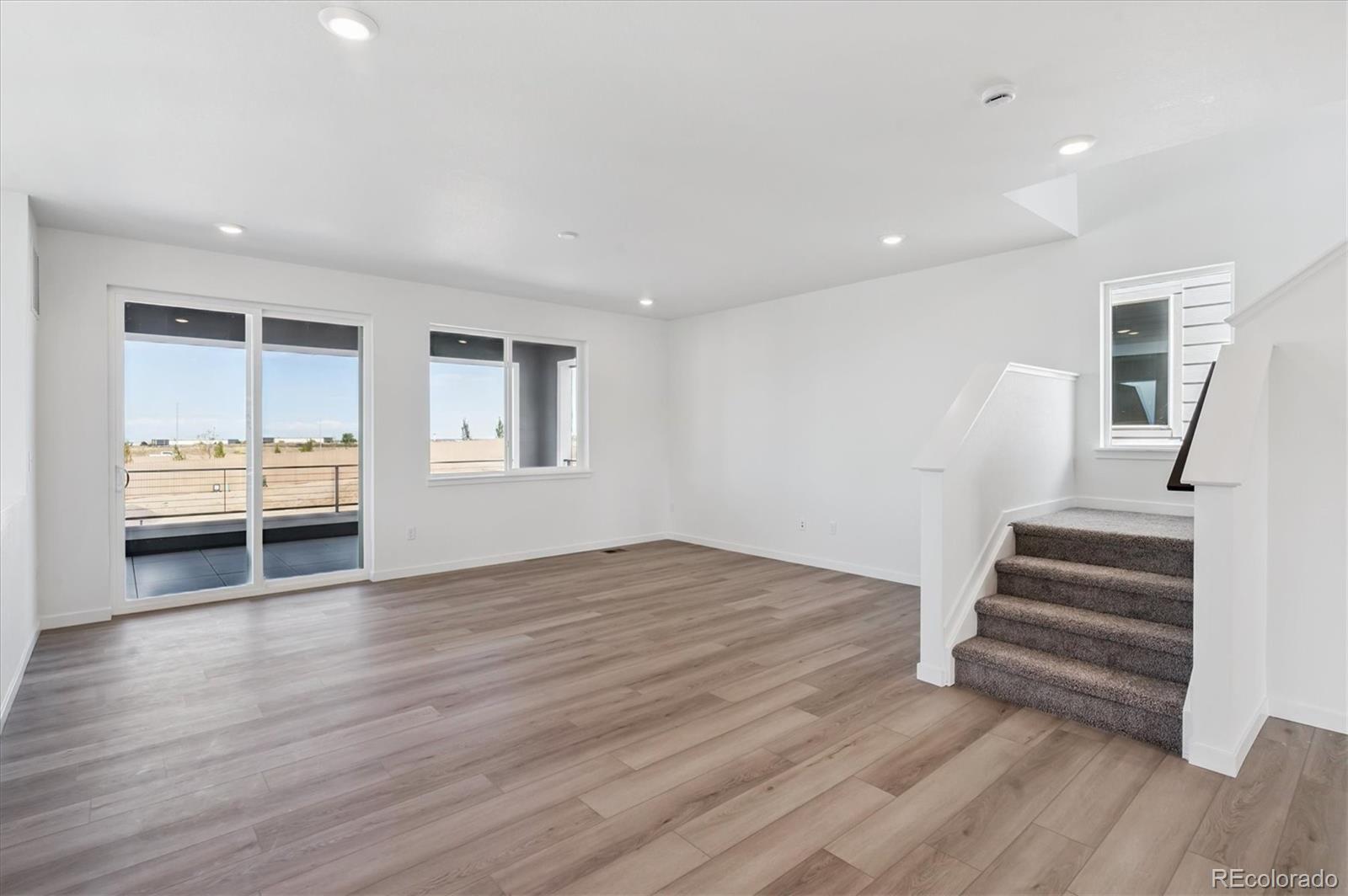 9123 White Ridge Road Englewood, CO 80112 - Photo 11 of 28 a view of empty room with wooden floor and fan